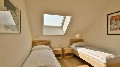 two beds in a small room with a window at Hotel Sparerhof in Vilpiano