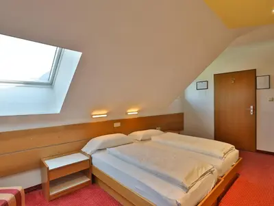 a bedroom with a large bed with a window at Hotel Sparerhof in Vilpiano