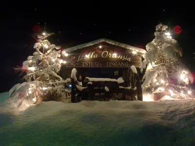 a lit up house with a christmas tree and lights at Villa Ortensia in San Vigilio Di Marebbe