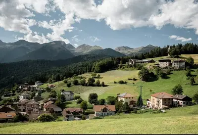 a village on a hill with mountains in the background at Casa 