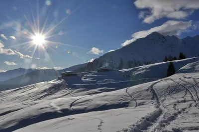 a snow covered mountain with the sun in the sky at Casa 