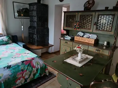 a bedroom with a bed and a table with a vase on it at Casa 