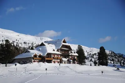 a building covered in snow on a snowy mountain at Hohe Gaisl in Braies