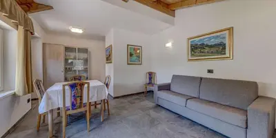 a living room with a couch and a table at Appartamento Luna in Campitello di Fassa