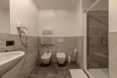a bathroom with a toilet and a sink and a shower at Appartamento Luna in Campitello di Fassa