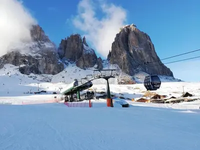 a ski lift in front of a snowy mountain at Appartamento Luna in Campitello di Fassa