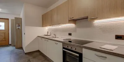 a kitchen with a sink and a counter top at Appartamento Luna in Campitello di Fassa