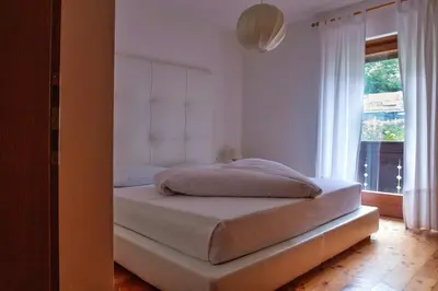 a bed in a bedroom with a window at Pension Sonnheim in Gargazzone