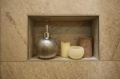 a shelf with a soap dispenser and candles on it at Pension Sonnheim in Gargazzone