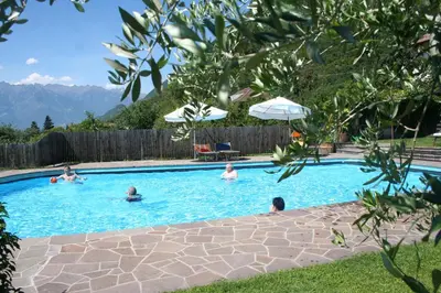 a group of people swimming in a swimming pool at Pension Sonnheim in Gargazzone