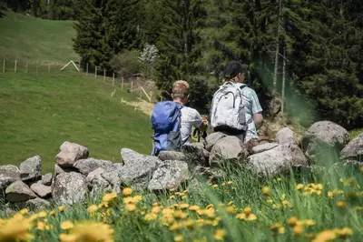 two people walking over a pile of rocks at Hotel Langeshof in Anterivo