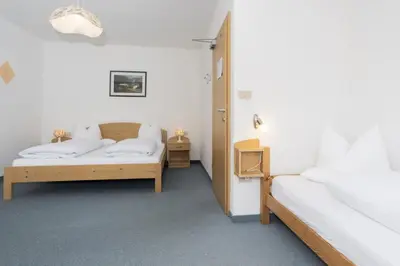 a bedroom with two beds and two night stands at Hotel Langeshof in Anterivo