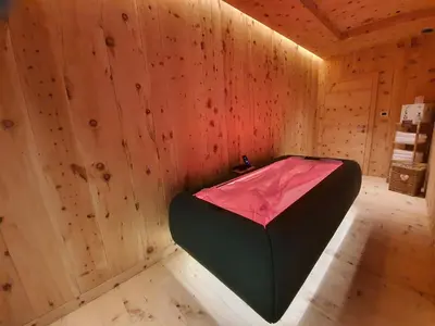 a wooden room with a black and pink inside at Dolomiti Lodge Alverà in Cortina dʼAmpezzo