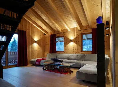 a living room with a couch and a table at Dolomiti Lodge Alverà in Cortina dʼAmpezzo