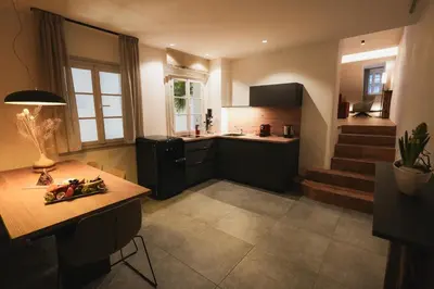 a kitchen with a counter and a table in it at Residence Rösch in Merano