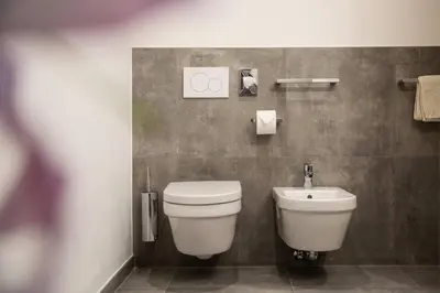 a bathroom with a toilet and a sink at Residence Rösch in Merano