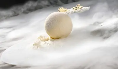 a egg sitting on top of a pile of snow at Hotel Weiher Green Lake in Falzes