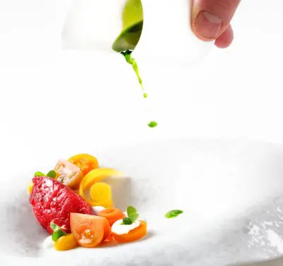 a plate of food with a strawberry and other fruits at Hotel Weiher Green Lake in Falzes