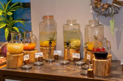 a group of glass jars filled with different types of liquids at Hotel Weiher Green Lake in Falzes