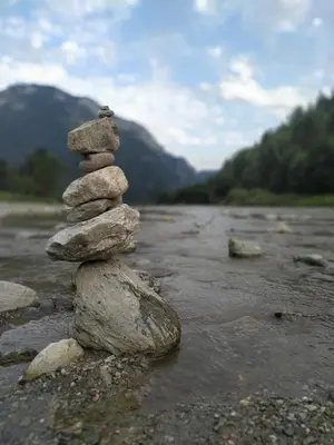 a stack of rocks sitting on top of a river at Eco-Baita Natura Spensierata in Canale San Bovo