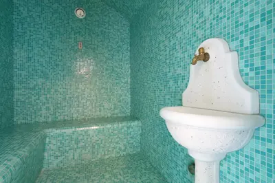 a blue bathroom with a toilet and a bath tub at Eco-Baita Natura Spensierata in Canale San Bovo