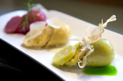 a plate of food with fruit on a table at Ladinia Dolomites View - Adults Only in Pozza di Fassa