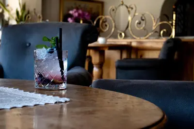 a glass with a plant in it sitting on a table at Ladinia Dolomites View - Adults Only in Pozza di Fassa