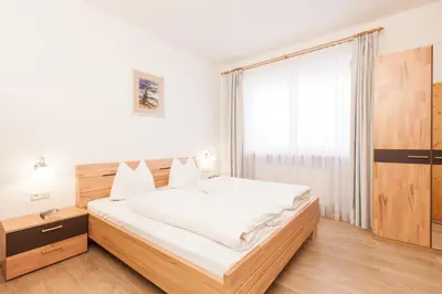 a bedroom with a large bed and a window at Residence Garni Melcherhof in Racines