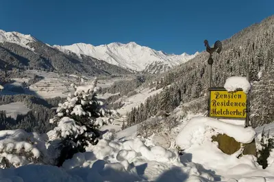 a sign on the side of a mountain with snow at Residence Garni Melcherhof in Racines