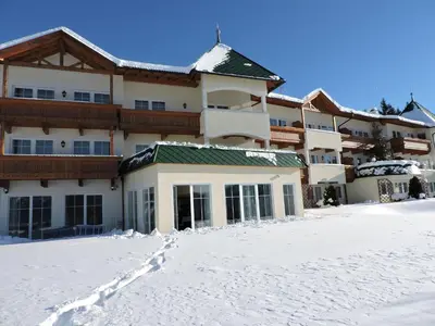 a large building with snow in front of it at Residence Rossboden mit Hallenbad in Verano
