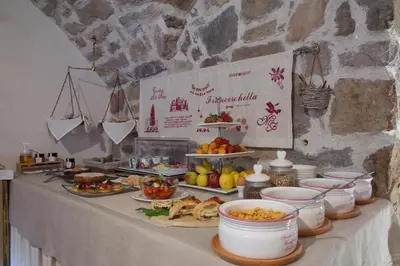a buffet of food on a table with plates of food at Maso Franceschella in Carano