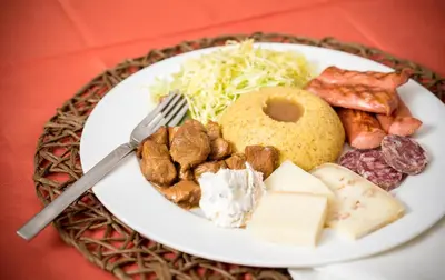 a plate of food with cheese and meats and cheeseabilia at Maso Franceschella in Carano