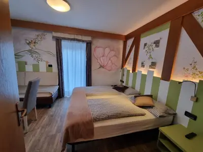 a bedroom with a large bed in a room at Hotel Aida in Pozza di Fassa