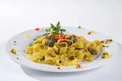 a plate of pasta on a white plate at Hotel Aida in Pozza di Fassa