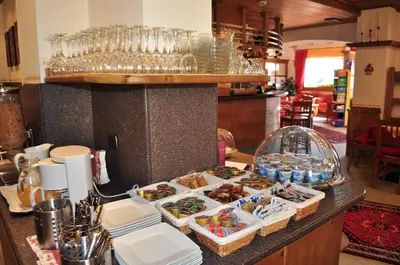 a counter with several trays of food on it at Residence Panorama in Falcade
