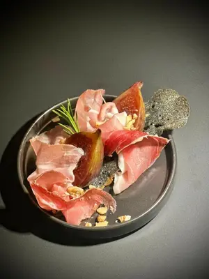 a white plate with some food on a table at Hirben Naturlaub in Villabassa