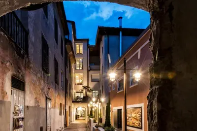 an alley in an old city at night at Guesthouse Suiteseven in Merano