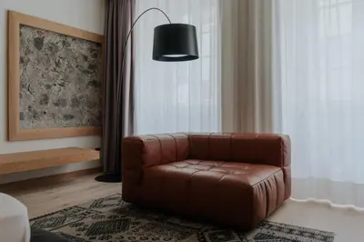 a brown leather chair sitting in front of a window at Guesthouse Suiteseven in Merano