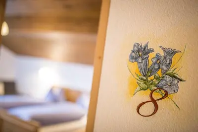 a drawing of a flower on a wall at Berggasthaus Agritur Moserhof in Braies