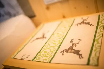 a table with a cake with drawings of deer on it at Berggasthaus Agritur Moserhof in Braies