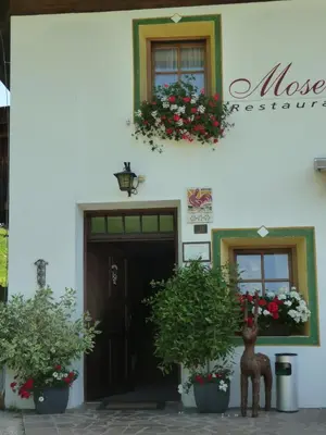 a building with a statue in front of it at Berggasthaus Agritur Moserhof in Braies
