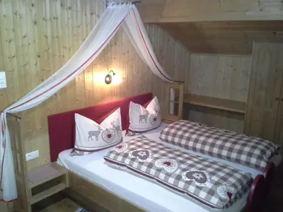 a bedroom with two beds in a wooden cabin at Berggasthaus Agritur Moserhof in Braies
