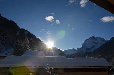 a view of a mountain range with snow covered mountains at Casa del bosco in Canazei