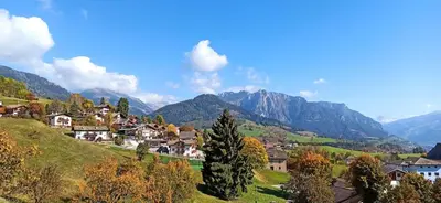 a town on a hill with mountains in the background at Alla Fontana Termale in Carano