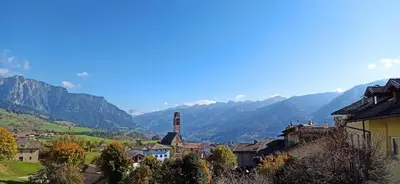 a city with mountains in the background and a town at Alla Fontana Termale in Carano