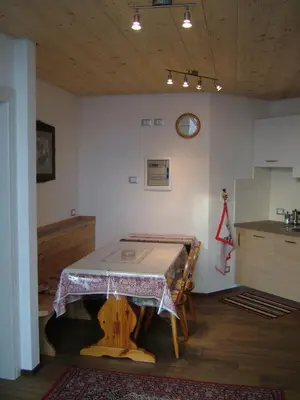 a white house with a porch and a tree at Alla Fontana Termale in Carano