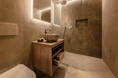 a bathroom with a sink and a shower at Apartments Ursus in San Cassiano