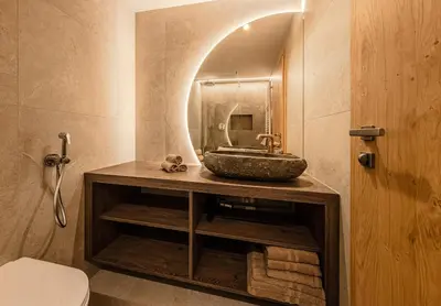 a bathroom with a sink and a mirror at Apartments Ursus in San Cassiano