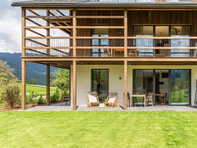 a house with a view of a lawn at KRONPLATZ CHALET WALCHHORN - Brunico, Dolomites in Brunico