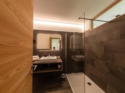 a bathroom with a sink and a mirror at KRONPLATZ CHALET WALCHHORN - Brunico, Dolomites in Brunico